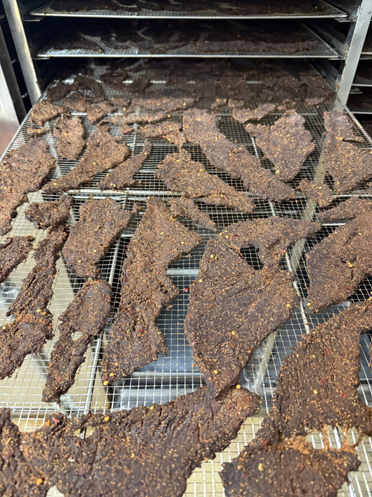 Beef jerky on trays at the factory